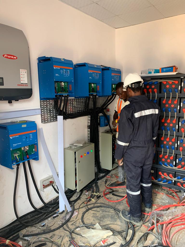 engineer installing inverters and batteries